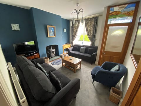 Spacious cosy lounge with 2 3 seater sofas and an easy chair & log stove