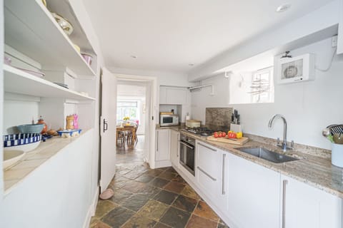 Albury House, Charmouth: The kitchen extends with a galley style prep area with second sink
