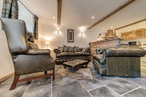Living room features Chesterfield sofa and chairs.