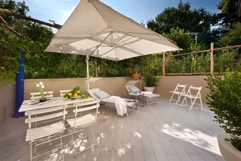 Terrace with dining table and chairs, BBQ, sun beds, garden, shower.