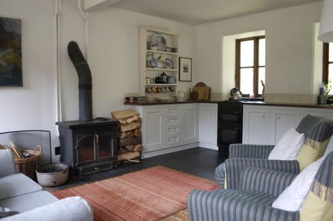 cosy wood burning stove and kitchen area
