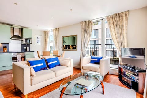 A bright living room with natural light and warm wooden floors.