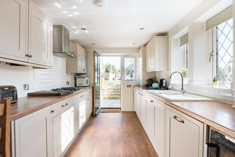 Galley kitchen with breakfast bar & stools