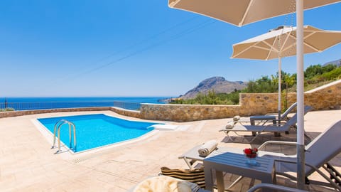 Pool area with sun beds and umbrellas