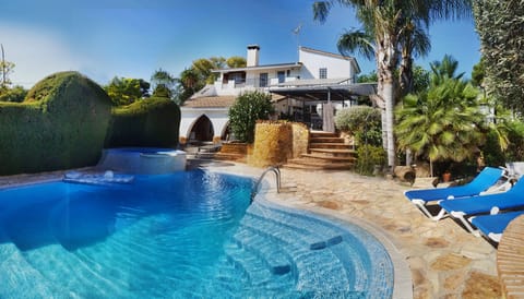 Front of house with pool and garden views