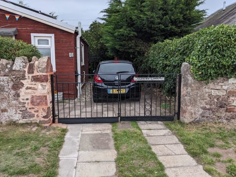 driveway for car parking. Small to medium size cars should be fine. 
Tesla sized cars will also manage