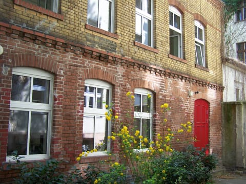 separate back building with entrance (red door)