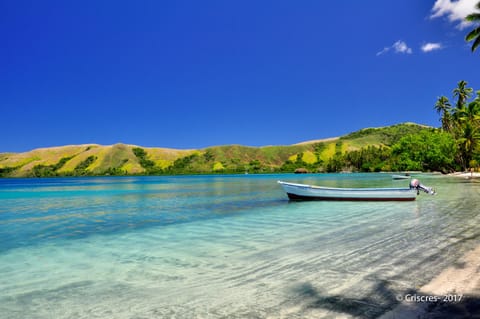 On the beach, white sand, sun loungers, beach towels