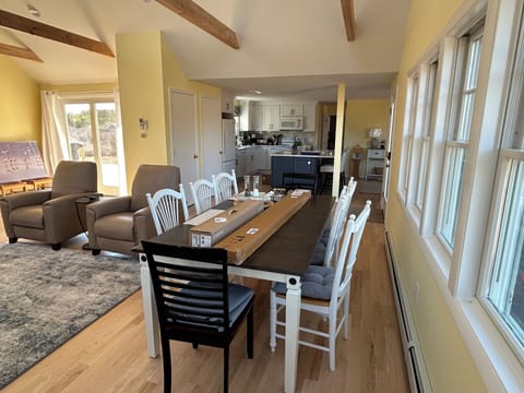 View of dining, kitchen & living room, showing sliders to deck.