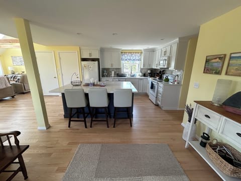 New kitchen with granite counters, oversized island, tile backsplash