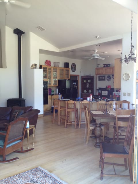 Open plan full kitchen with peninsula bar seating, great room pellet furnace