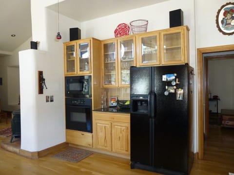 Fully stocked kitchen with full size appliances. Wine opener on left wall.