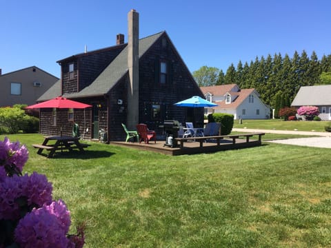 Side deck + entry, 6 seat patio set, picnic table, gas grill, Adirondack chairs.