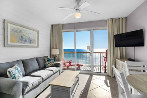 Living Room -Step into coastal luxury with this airy beachfront living room, boasting cozy seating, a large flat-screen TV, and endless ocean views for total comfort.