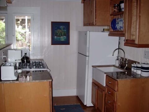 Kitchen area with microwave, toaster, and blender.