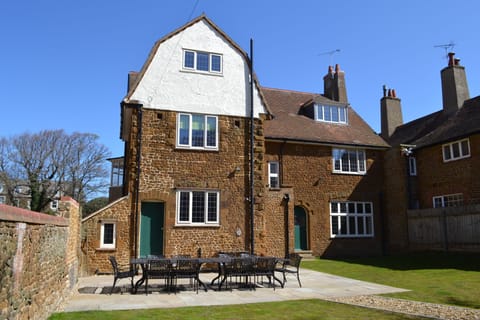 Rear of the house with enclosed garden and patio.