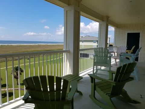 Balcony with 4 bar stool chairs and table, 2 rocking chairs and small table.