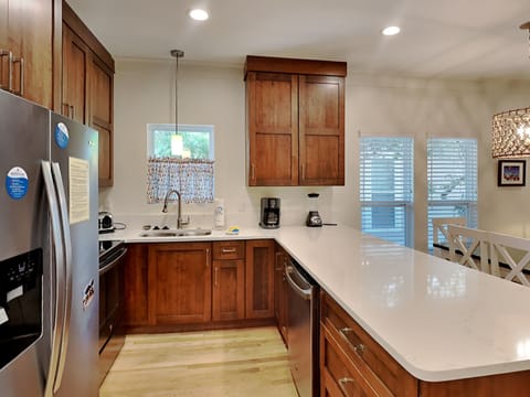 Another view of all the storage and new appliances in the light-filled kitchen