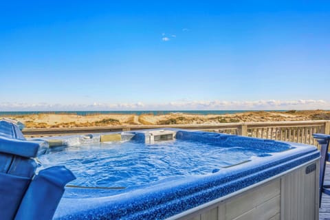 Soak in your private hot tub while gazing at endless ocean views and rolling dunes—pure coastal bliss awaits.