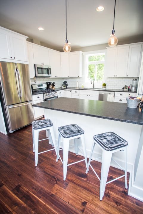 Beautiful, fully stocked gourmet kitchen with additional seating at the island.