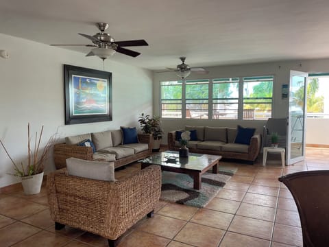 Spacious open plan living room, dinning and kitchen area, with balcony.