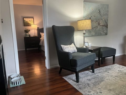 View from front room into bedroom with king bed.