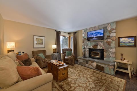 Settle into the inviting gathering space anchored by a hand-laid hearth — the perfect backdrop for swapping stories after slope-side adventures.