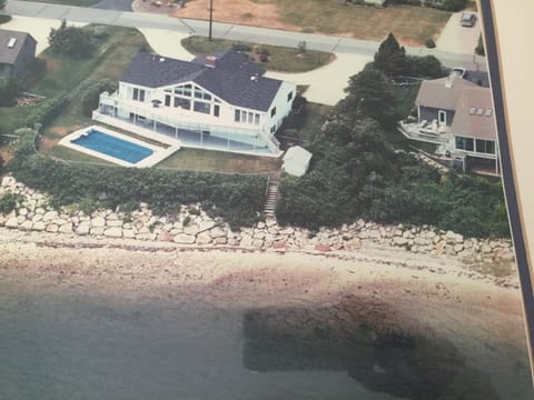 Aerial view of our home, swimming pool, upper& lower decks, steps down to Harbor