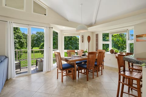 The dining table seats six with the golf course rolling out just past the windows.