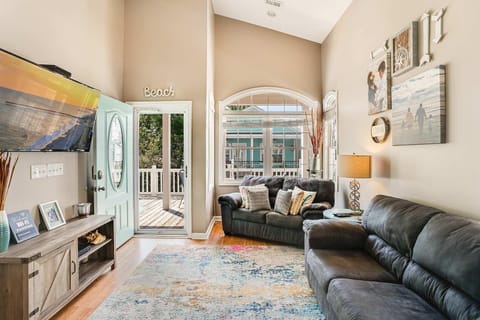 Sunlit living room with vaulted ceilings and cozy seating