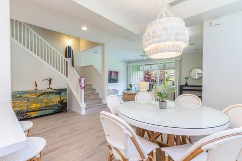Light-filled dining space beneath statement chandelier
