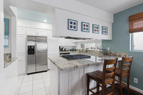 The breakfast bar seating makes meal time a social affair.
                