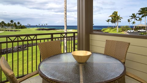 Lanai with glass-topped table and seating.