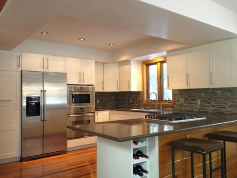 remodeled kitchen with stainless steel appliances, marble counter tops and gas 
