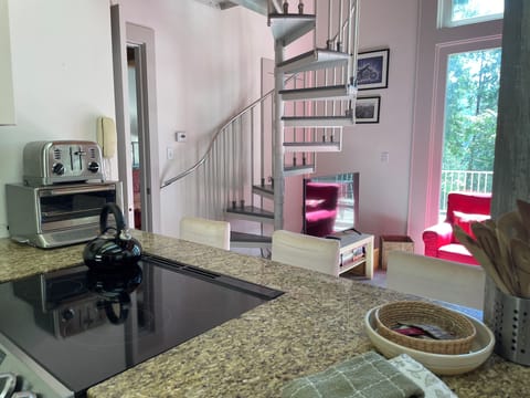 Living room and spiral staircase from kitchen.