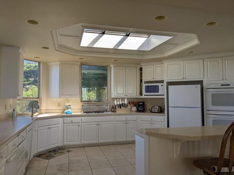 Spacious kitchen: 2 sinks, 5-burner stove-top, dishwasher, and microwave.