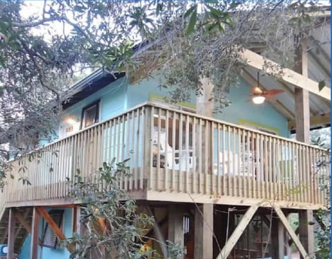 "Front" of the home facing south featuring the covered balcony living space.