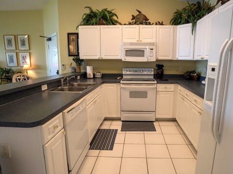 Large, open kitchen with updated appliances and gourmet cookware