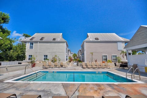 Resort-style community pool surrounded by tropical landscaping.