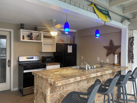 Outdoor kitchen with gas stove and full size refrigerator