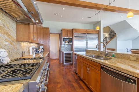 This kitchen is enormous! It is fully stocked with all cooking supplies!