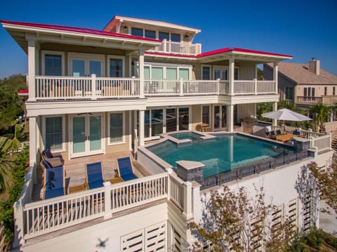 Luxury Oceanfront Living – Gorgeous back exterior with infinity-style pool and sundeck overlooking the ocean.
