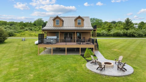 Front view of Castello with large yard, firepit, deck, and hot tub