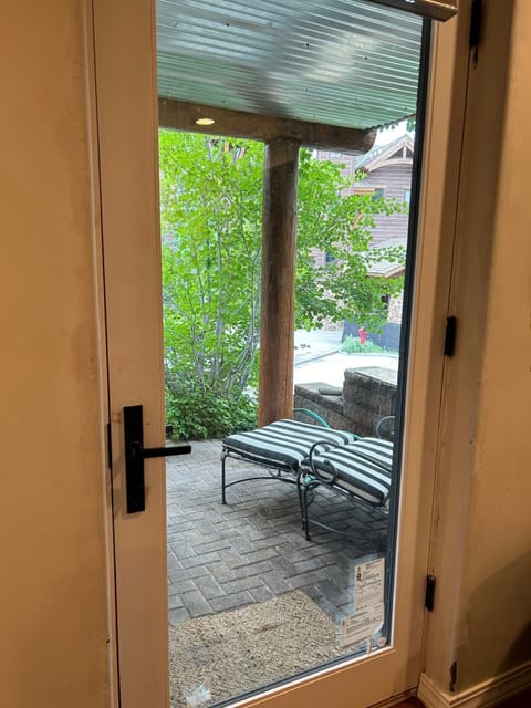 View from inside Bedroom one looking at small, private seating outside.