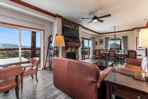 Living Room TV, fireplace, dining area,  open to deck w/ Hot Tub. Kitchen right