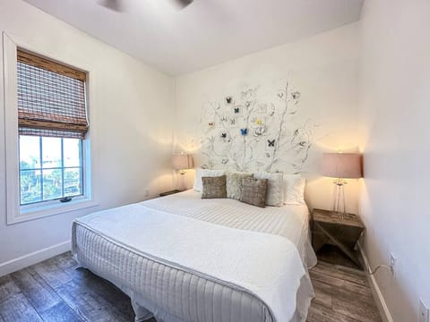 Plush king bed is nestled behind the divider wall affording privacy