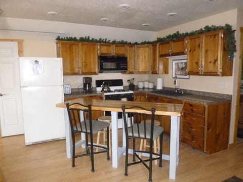 Kitchen area with bar which seats up to six