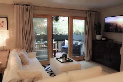 Comfortable Living Room with large smart TV and access to deck.