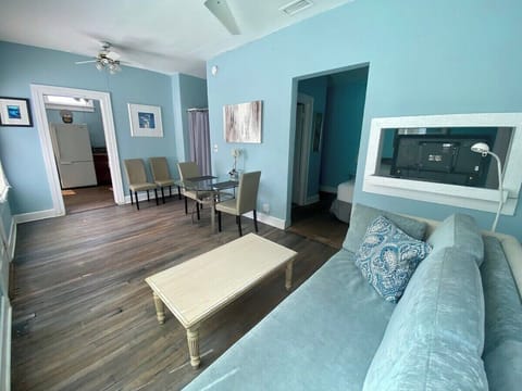 The doorway to the right of the sofa is the bedroom and bathroom. The bedroom does not have a door. 