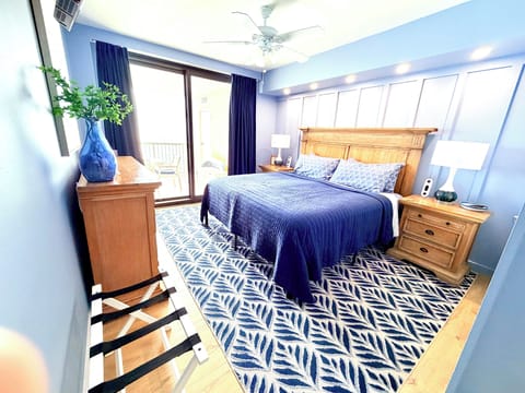 Primary bedroom with king bed and direct balcony access.